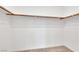 Walk-in closet with carpeted floor and wooden shelves/hanging rods at 234 Walsh Peak Ave, Henderson, NV 89015