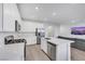 Modern kitchen features a quartz countertop, stainless steel appliances and is open to the living room at 234 Walsh Peak Ave, Henderson, NV 89015