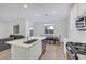 Open kitchen features a center island with sink, stainless appliances, and dining adjacent to the living room at 234 Walsh Peak Ave, Henderson, NV 89015
