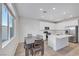 Open kitchen boasts stainless steel appliances, an island, and dining area with a table and chairs at 234 Walsh Peak Ave, Henderson, NV 89015
