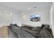 Comfortable living room with a gray sectional sofa, wood floors, and a mounted TV at 234 Walsh Peak Ave, Henderson, NV 89015