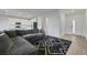 Spacious living room with hardwood floors, a sectional sofa and easy access to the kitchen at 234 Walsh Peak Ave, Henderson, NV 89015