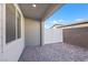 Small patio with brick pavers and a partial view of houses and a fence at 234 Walsh Peak Ave, Henderson, NV 89015