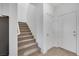 Bright, carpeted staircase features white walls, handrail, and natural light, enhancing the home's modern appeal at 234 Walsh Peak Ave, Henderson, NV 89015