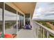 A colorful balcony with outdoor furniture and glass doors that provide an open and airy space at 3111 Bel Air Dr # 15D, Las Vegas, NV 89109