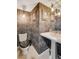 Elegant powder room featuring patterned wallpaper, a pedestal sink, and decorative lighting at 3111 Bel Air Dr # 15D, Las Vegas, NV 89109
