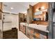 Elegant bathroom featuring dual sinks, a glass shower, and closet at 3111 Bel Air Dr # 15D, Las Vegas, NV 89109