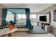 Modern bedroom featuring a stylish four-poster bed, TV, and a sliding glass door to the balcony with city views at 3111 Bel Air Dr # 15D, Las Vegas, NV 89109