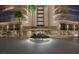 Elegant Regency Towers entrance featuring a lush roundabout and well-maintained landscaping at 3111 Bel Air Dr # 15D, Las Vegas, NV 89109