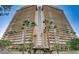 Exterior view of the Regency Towers building featuring multiple stories, balconies, and palm trees at 3111 Bel Air Dr # 15D, Las Vegas, NV 89109