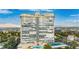 Exterior view of the condo building, surrounded by green trees, pool, tennis court, and other amenities at 3111 Bel Air Dr # 15D, Las Vegas, NV 89109