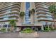 Regency Towers exterior with manicured landscaping and palm trees at the front entrance, for a serene welcome at 3111 Bel Air Dr # 15D, Las Vegas, NV 89109