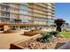 Exterior view of high-rise building showing landscaped grounds, outdoor seating, and common areas at 3111 Bel Air Dr # 15D, Las Vegas, NV 89109