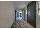 Hallway featuring decorative carpet, lighting, marble accents, and an entryway to a room beyond at 3111 Bel Air Dr # 15D, Las Vegas, NV 89109
