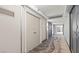 Hallway with gray doors, decorative carpet, and access to units within the tower at 3111 Bel Air Dr # 15D, Las Vegas, NV 89109
