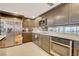 Modern kitchen featuring sleek cabinets, stainless steel appliances, and countertops with a mirrored backsplash at 3111 Bel Air Dr # 15D, Las Vegas, NV 89109