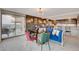 Bright living room featuring modern furniture, access to balcony with city views, and kitchen at 3111 Bel Air Dr # 15D, Las Vegas, NV 89109