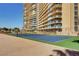 Outdoor tennis court with high-rise building in the background and blue playing surface at 3111 Bel Air Dr # 15D, Las Vegas, NV 89109