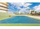 A well-maintained tennis court with palm trees in the background and bench seating for comfortable viewing at 3111 Bel Air Dr # 15D, Las Vegas, NV 89109