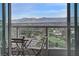 A stunning balcony view features outdoor seating, verdant trees, a golf course and mountains in the distance at 322 Karen Ave # 2206, Las Vegas, NV 89109