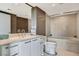 Bright bathroom featuring a double vanity, white cabinets, and a soaking tub at 322 Karen Ave # 2206, Las Vegas, NV 89109