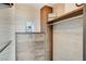 Custom closet with wood cabinets, drawers, shelving and decorative wallpaper at 322 Karen Ave # 2206, Las Vegas, NV 89109