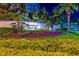 Night view of Turnberry Towers entrance with lush landscaping and colorful flower beds at 322 Karen Ave # 2206, Las Vegas, NV 89109