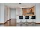 A modern kitchen features stainless steel appliances, a breakfast bar with seating and hardwood flooring at 322 Karen Ave # 2206, Las Vegas, NV 89109