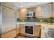 A modern kitchen features stainless steel appliances, granite countertops and wooden cabinetry at 322 Karen Ave # 2206, Las Vegas, NV 89109