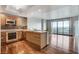 Open kitchen with stainless steel appliances, wood cabinets, and balcony access at 322 Karen Ave # 2206, Las Vegas, NV 89109