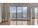 A sun-drenched living room features hardwood floors, an adjoined balcony, and views of the city skyline at 322 Karen Ave # 2206, Las Vegas, NV 89109