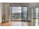 A living room with hardwood floors and natural light leads to a spacious adjoined balcony with city views at 322 Karen Ave # 2206, Las Vegas, NV 89109