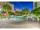 Lagoon-style pool area with lush landscaping, rock features, and comfortable lounge chairs at 322 Karen Ave # 2206, Las Vegas, NV 89109