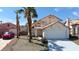 Two-story home with desert landscaping, 2-car garage, and terracotta tile roof, offering curb appeal at 3275 Canyon Terrace Dr, Laughlin, NV 89029