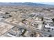 Expansive aerial view of a desert community with mountain backdrop, showcasing neighborhood layout and scenery at 3581 Ranger Way, Pahrump, NV 89048