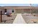 Backyard featuring a stone path, gravel landscaping, outdoor seating, and fire pit for relaxing and entertaining at 3581 Ranger Way, Pahrump, NV 89048