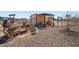 Rustic backyard featuring an old wooden cart, rock features and wood storage at 3581 Ranger Way, Pahrump, NV 89048