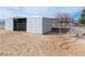 Metal horse barn with individual stalls surrounded by dirt, providing a functional space for livestock at 3581 Ranger Way, Pahrump, NV 89048