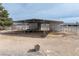 Outdoor barn structure with metal roof and horse fencing in a desert landscape, perfect for equestrian activities at 3581 Ranger Way, Pahrump, NV 89048