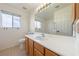 Bright bathroom features a large mirror, sink, and tile flooring at 3581 Ranger Way, Pahrump, NV 89048