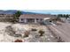 Single-story home with a covered carport, landscaped yard, and desert surroundings, showcasing outdoor charm at 3581 Ranger Way, Pahrump, NV 89048