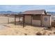 Outbuilding with 'Tack Room' sign, barn door, and fenced horse area, adding rustic charm to the equestrian property at 3581 Ranger Way, Pahrump, NV 89048