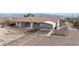 Spacious ranch home with a covered carport, gravel landscaping, and mountain views in a rural setting at 3581 Ranger Way, Pahrump, NV 89048