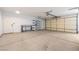 Spacious two car garage with concrete floor, utility door, storage shelves, and an automatic door opener at 3581 Ranger Way, Pahrump, NV 89048