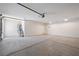 Spacious garage with concrete flooring and door to outside at 3581 Ranger Way, Pahrump, NV 89048