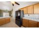 Open kitchen design with oak cabinetry, island, and views at 3581 Ranger Way, Pahrump, NV 89048