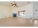 Bright living room featuring tile flooring, fireplace, ceiling fan and a door to the backyard at 3581 Ranger Way, Pahrump, NV 89048