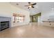 Spacious living room with tile floors, a cozy fireplace, and views to a screened in outdoor patio area at 3581 Ranger Way, Pahrump, NV 89048