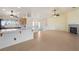Open-concept living area with tile floors, breakfast bar, fireplace and smooth transitions to the kitchen at 3581 Ranger Way, Pahrump, NV 89048
