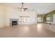 Bright living room featuring tile flooring, fireplace, ceiling fan and plenty of natural light at 3581 Ranger Way, Pahrump, NV 89048